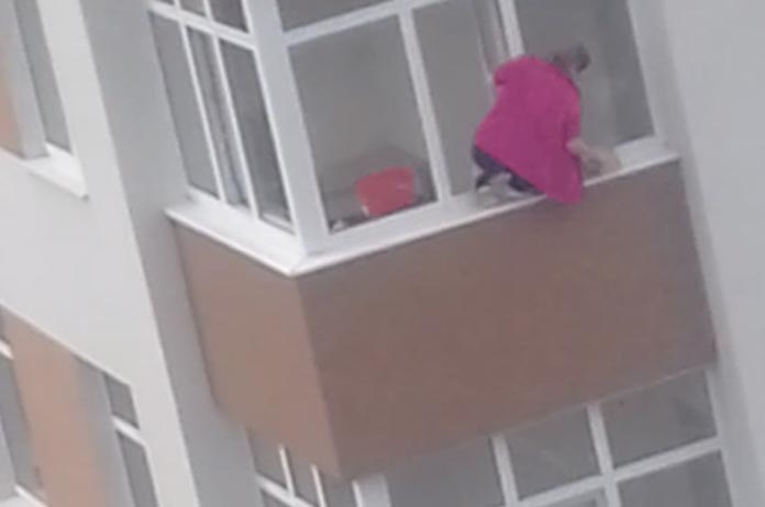 Je krijgt ongetwijfeld zweethandjes als je ziet hoe deze dame buitenramen poetst (video)