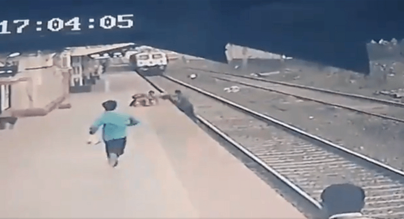 WOW. Arbeider redt kind op het nippertje van aanstormende trein (video)