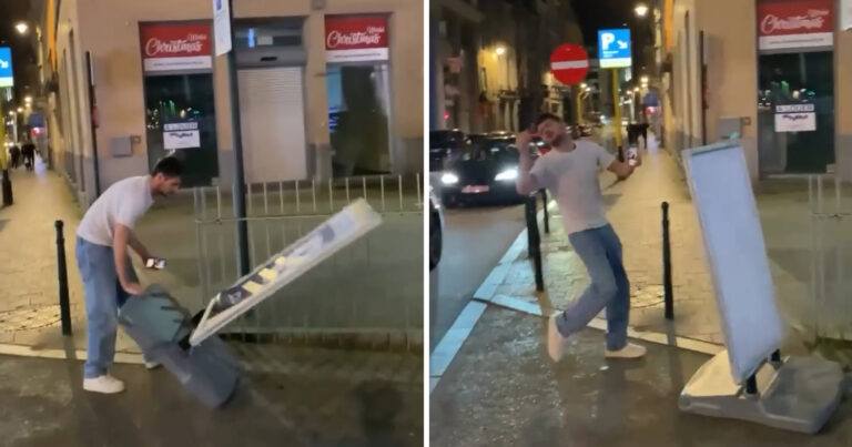 Man wil reclamebord rechtzetten, maar krijgt het deksel op de neus (video)